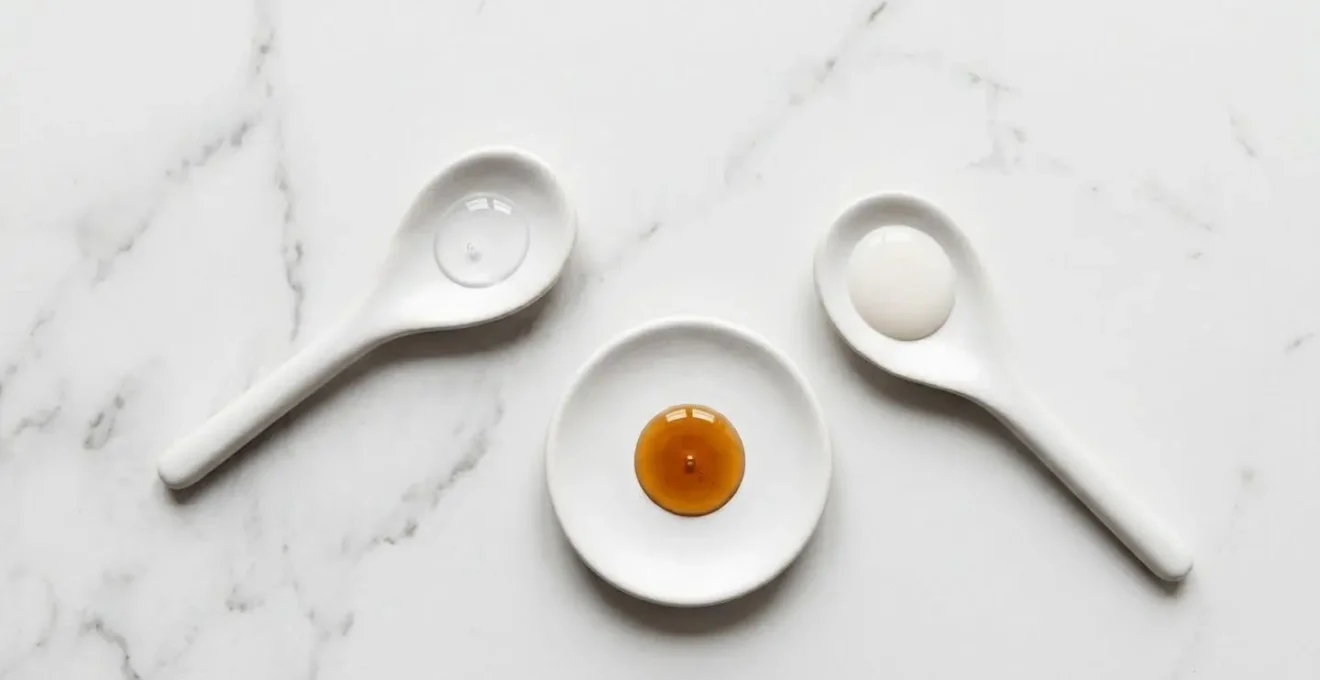 Composición minimalista de texturas cosméticas mostrando diferentes formulaciones de sueros antioxidantes